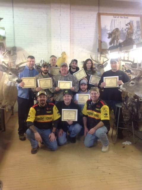 Image of group with taxidermy certificates
